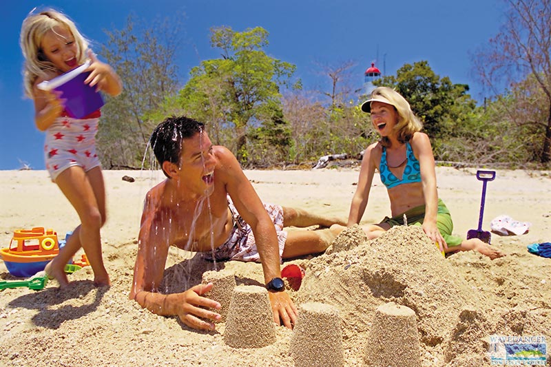 family building sand castle on the beach